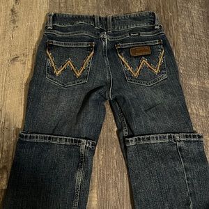 Boot cut, dark wash wranglers.